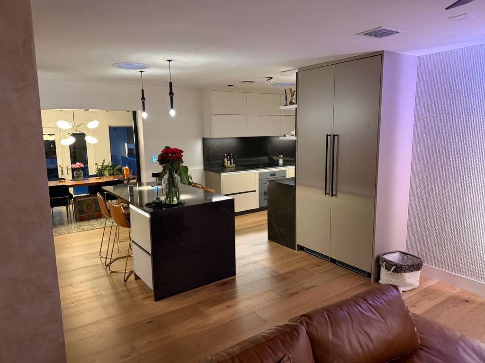 Finished condo kitchen — two-tone cabinets with an integrated paneled refrigerator