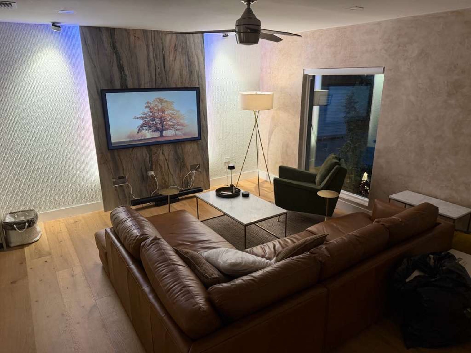 Completed New Season Designs living room with a stone-slab feature wall and LED accent lighting