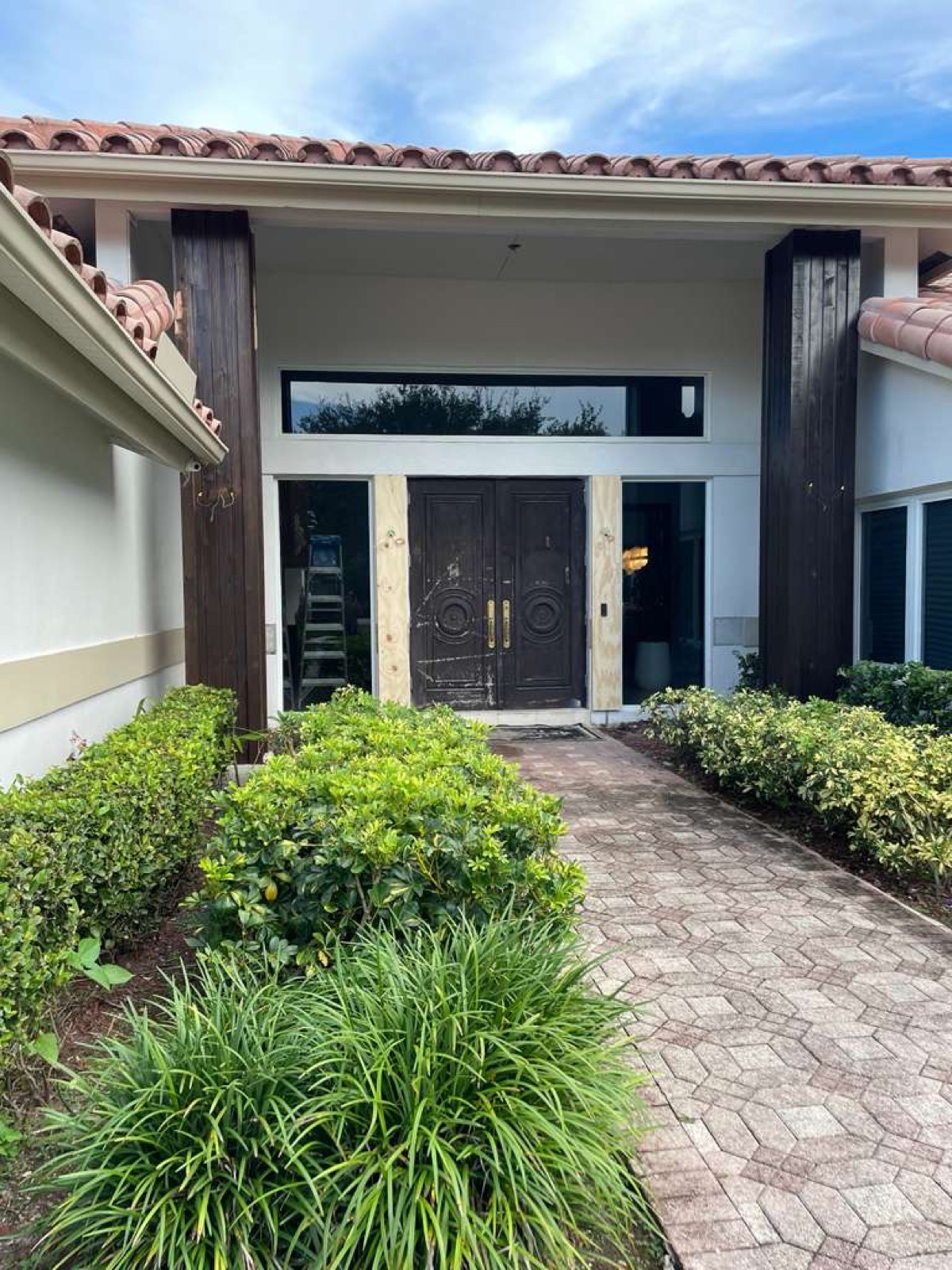 Entryway mid-construction — raw wood columns and doors before finishing