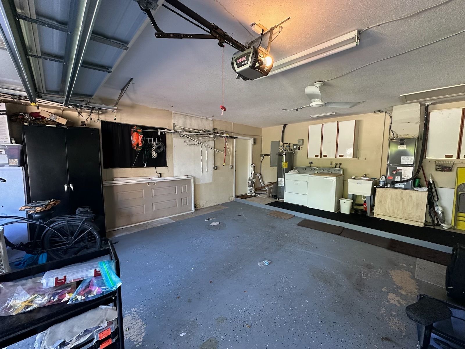 Garage before — cluttered storage with stained concrete floor