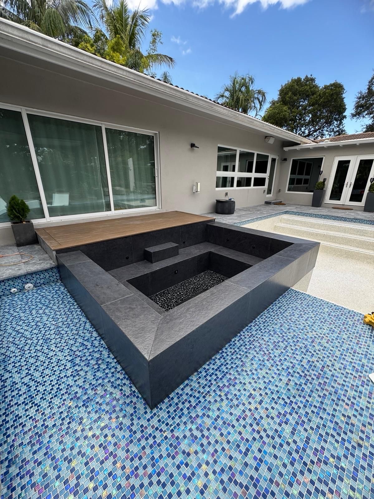 Completed New Season Designs project — finished pool and raised spa with glass-mosaic tile