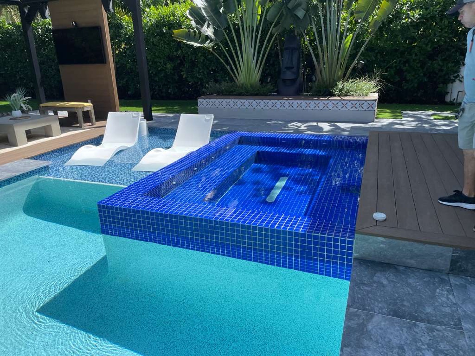 Pool and spa after — finished blue glass-mosaic raised spa and clear pool water