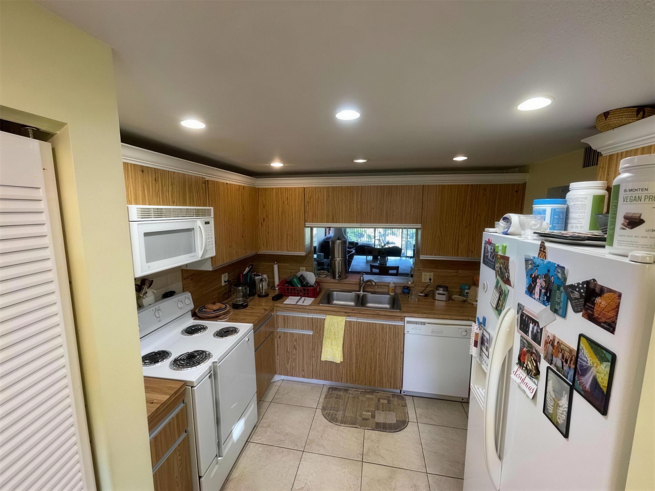 Kitchen before — dated 90s oak-slat cabinets