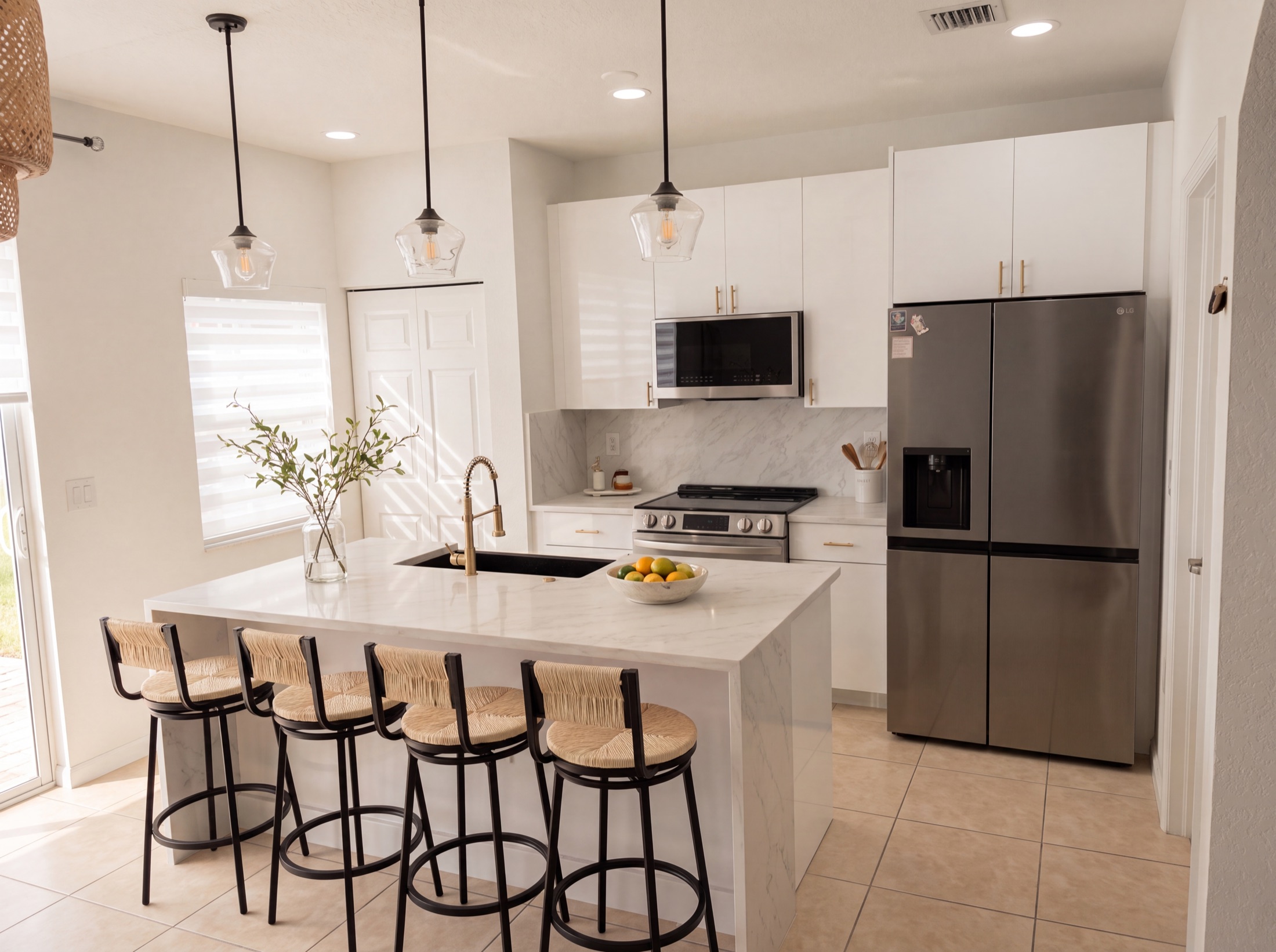 Finished kitchen — white quartz island with seating for four