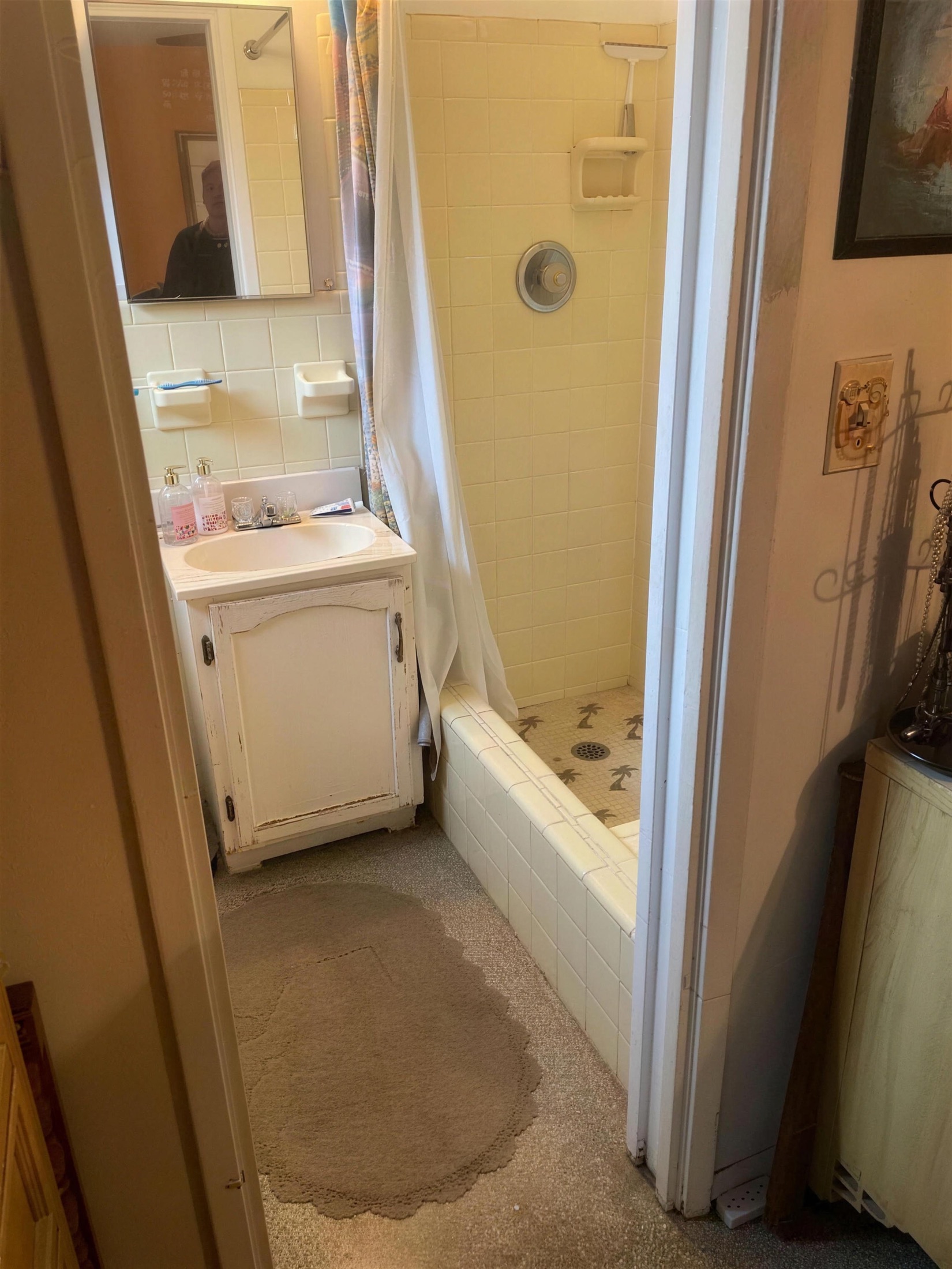 Bath before — old yellow-tile tub and carpeted floor